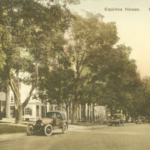 A vintage postcard shows a street with classic cars, trees, and the Equinox House in Manchester, Vermont.